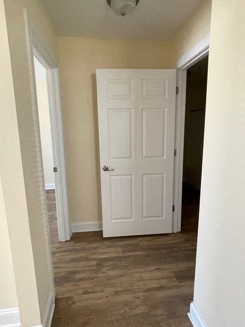 A white door is in a room with a brown floor.