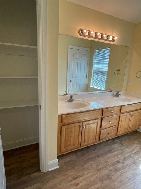A bathroom with a vanity and a mirror.