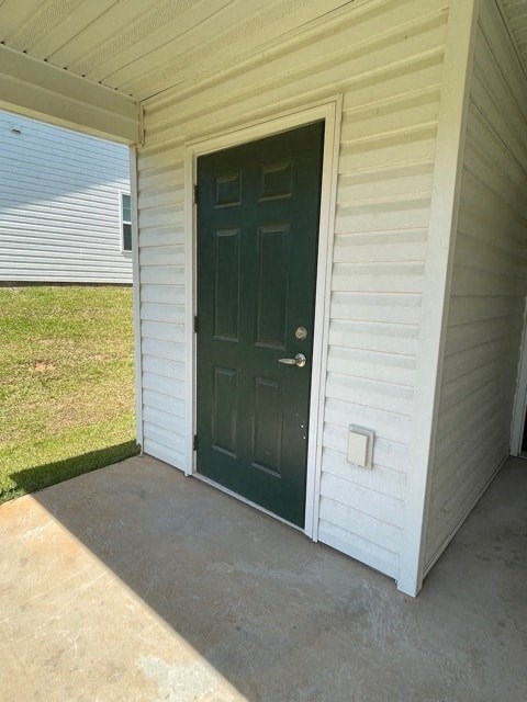 A white house with a green door.