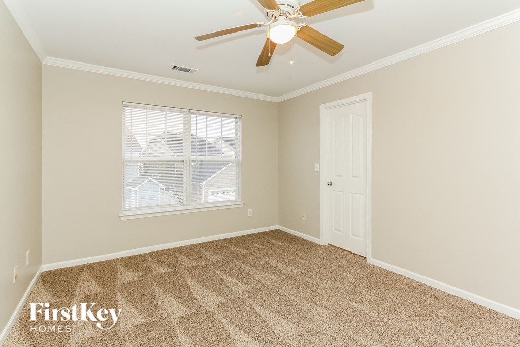 the master bedroom has a ceiling fan and carpeted flooring