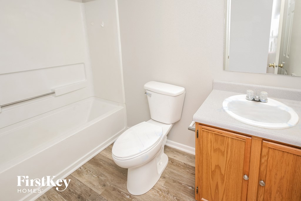 a bathroom with a toilet and a sink and a bath tub