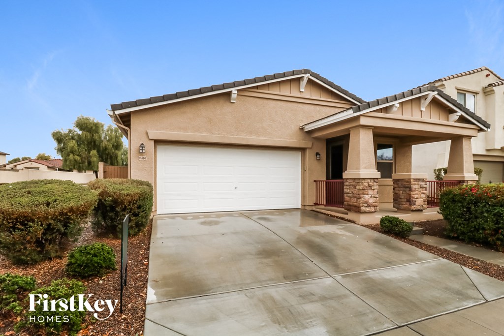 A house with a garage and a driveway is for sale.