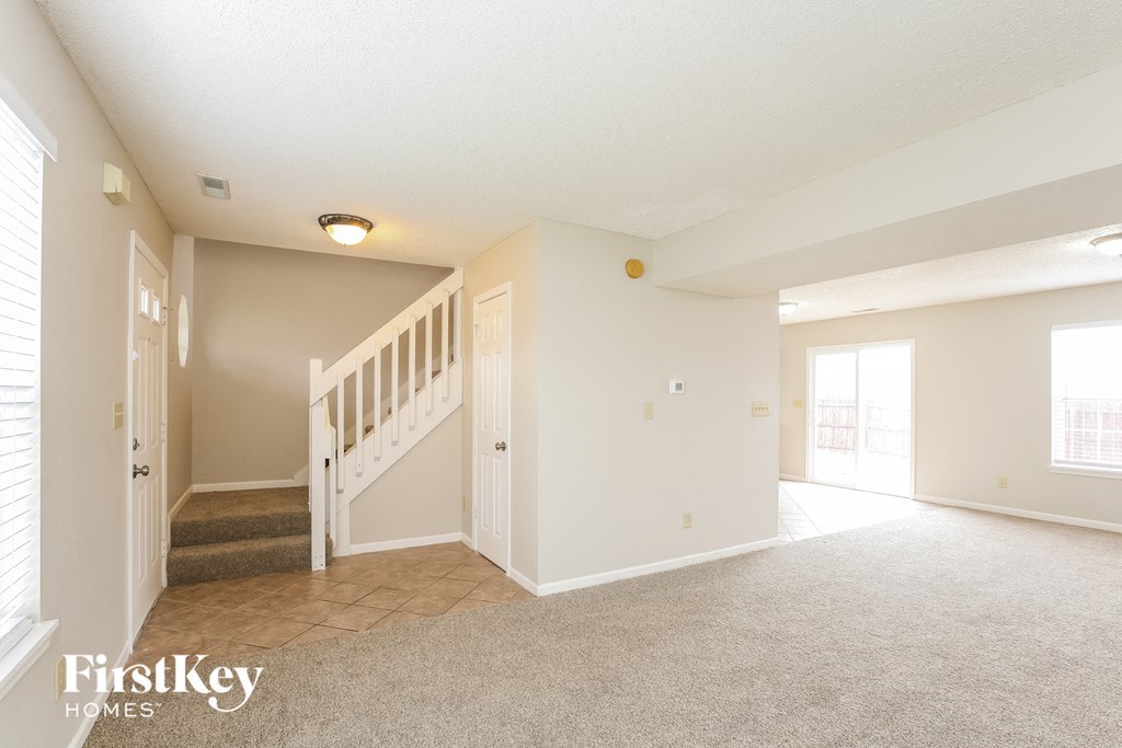 the living room and entryway of an empty house
