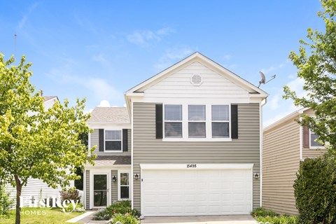 a gray house with a white garage door
