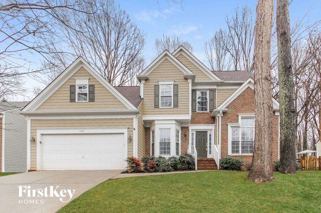 a beige house with a white garage door