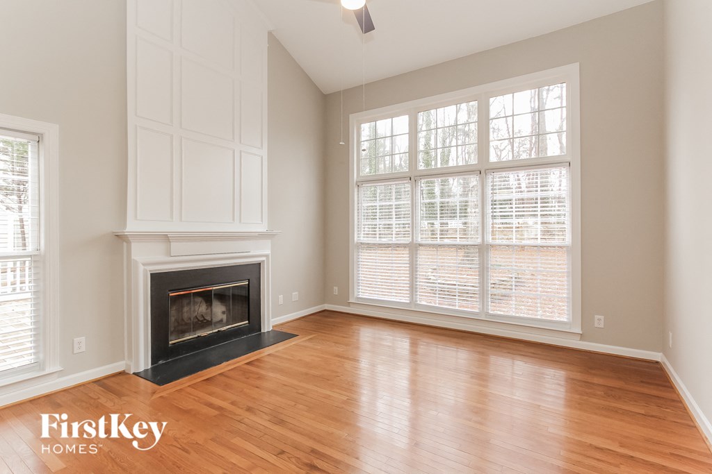 a living room with a fireplace and a wooden floor