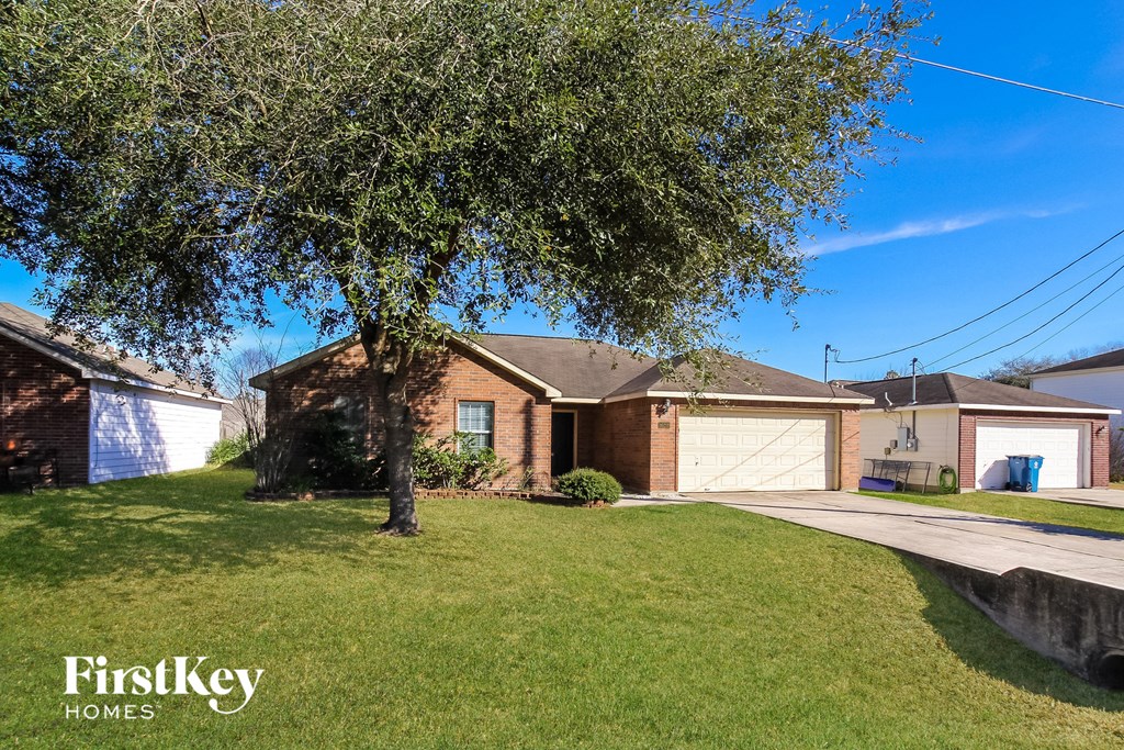 A house with a tree in front of it and the words "FirstKey Homes" on the bottom left.