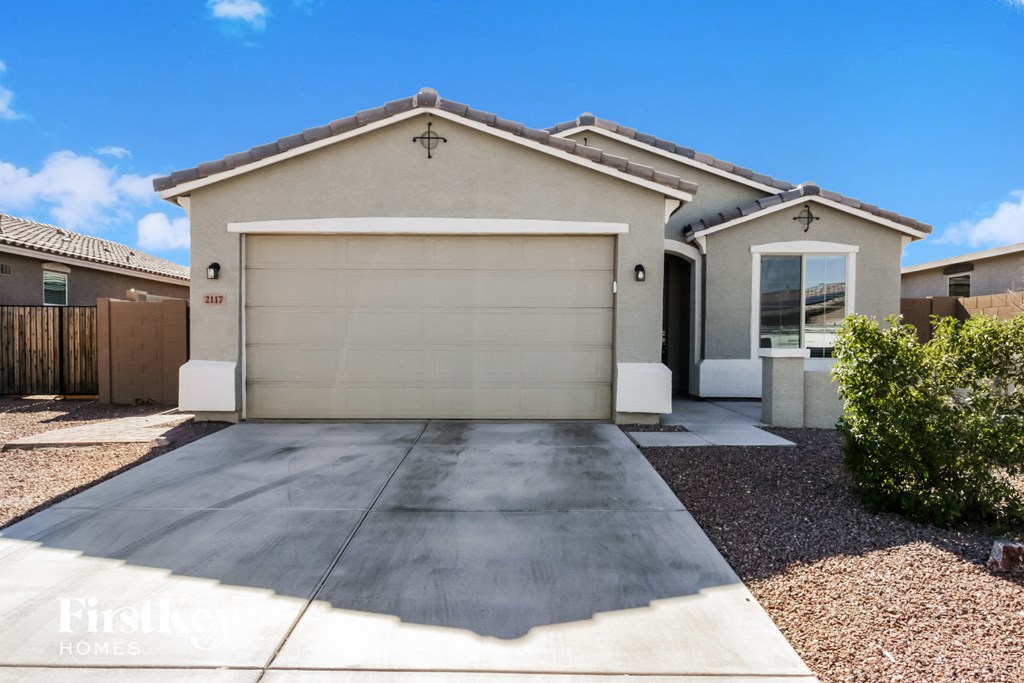 A modern house with a garage door and a driveway.