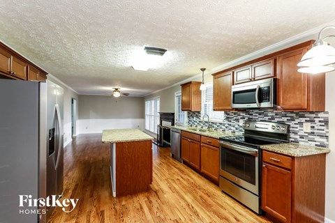 a kitchen with wooden cabinets and stainless steel appliances