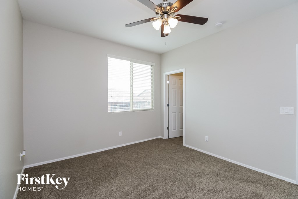 a living room with a ceiling fan and a window