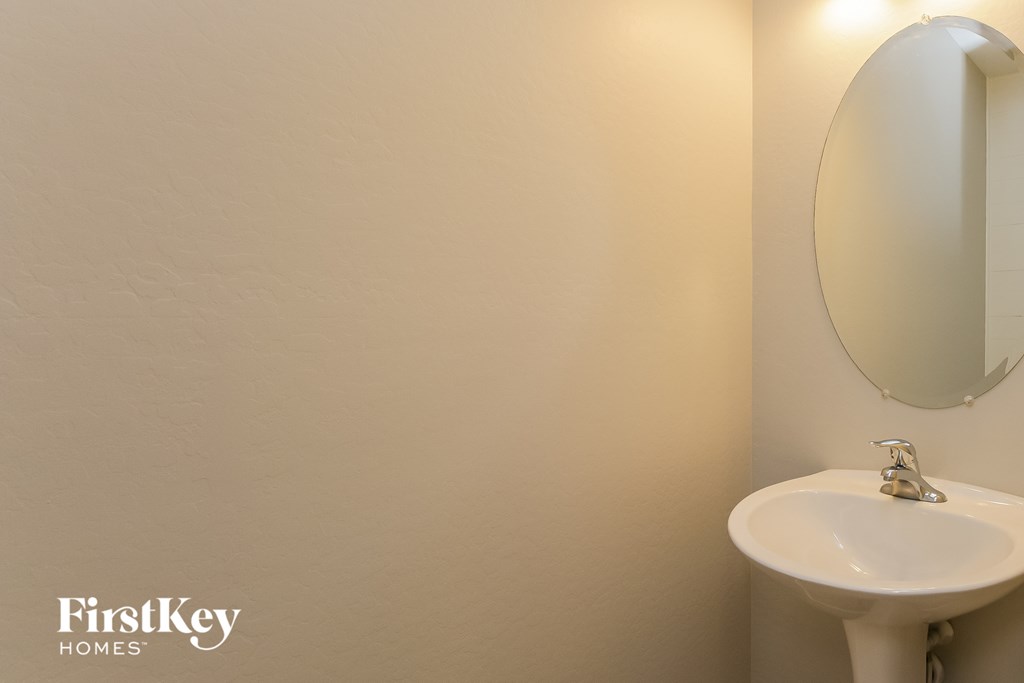a bathroom with a sink and a mirror and a toilet