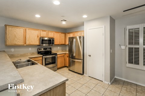 A kitchen with wooden cabinets and stainless steel appliances.