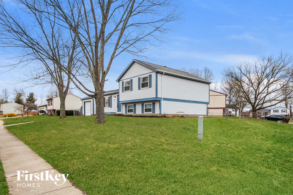 a blue and on a green lawn next to a sidewalk