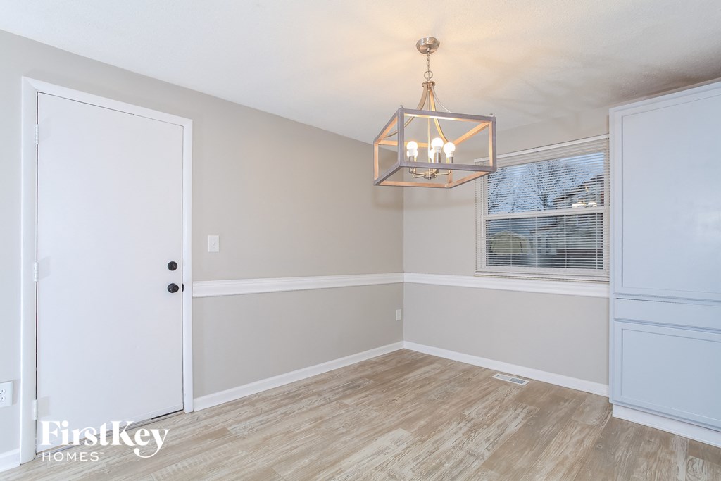 a dining room with a chandelier and a window