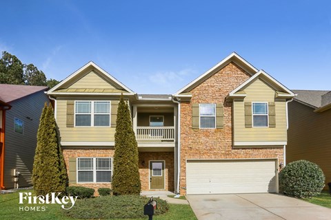 a house with two stories and a white garage door