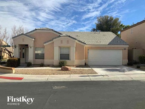 a house with a garage and a street in front of it