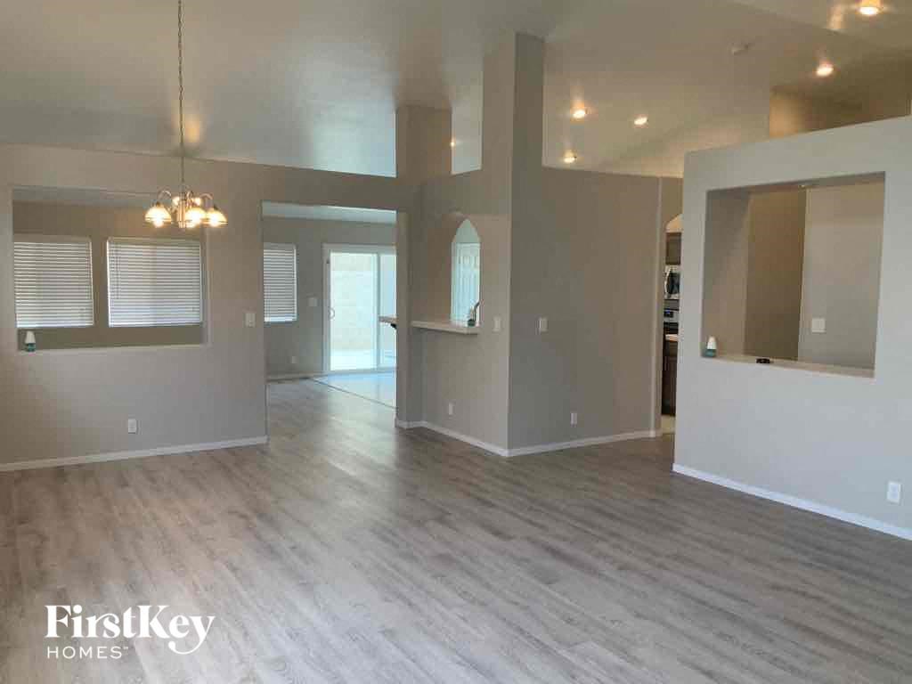 an empty living room with a hard wood floor