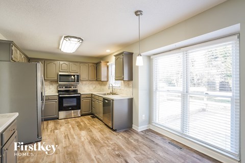 a kitchen with stainless steel appliances and a large window