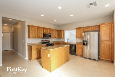 a kitchen with wooden cabinets and stainless steel appliances