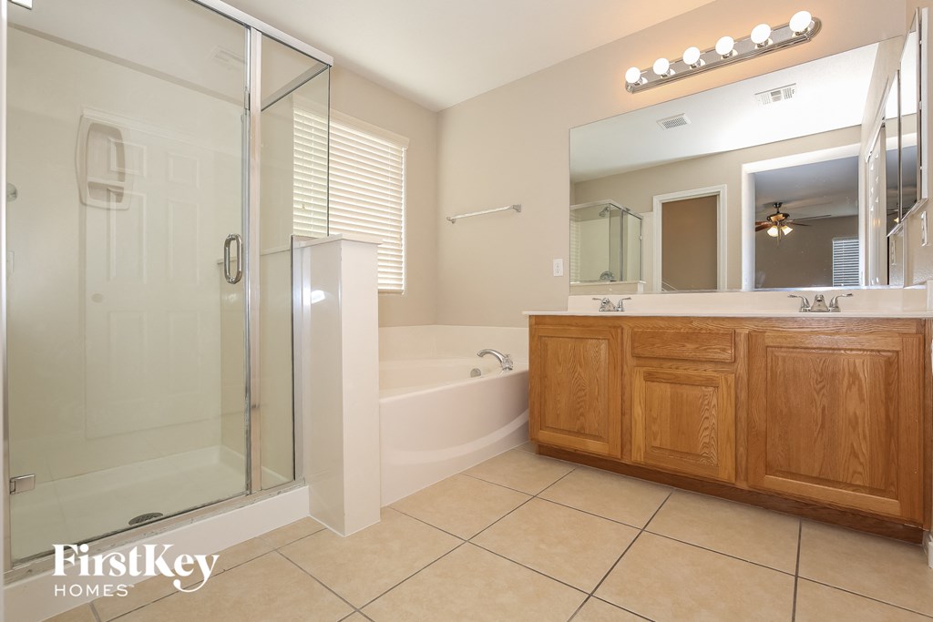 a bathroom with a shower and a sink and a bath tub
