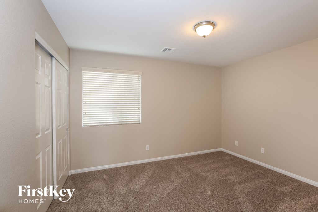 the upstairs bedroom has carpet and a door to the bathroom