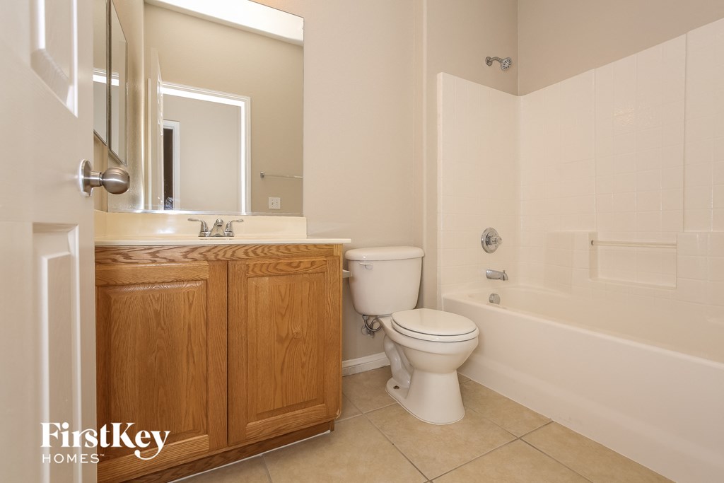a bathroom with a toilet and a sink and a bath tub