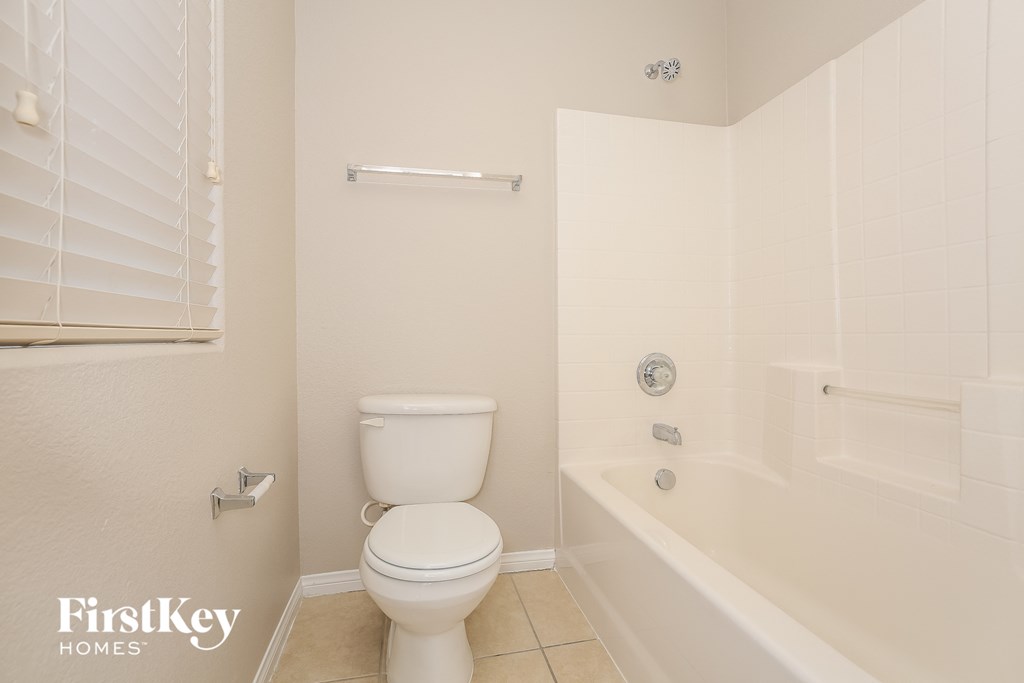 a bathroom with a toilet and a tub