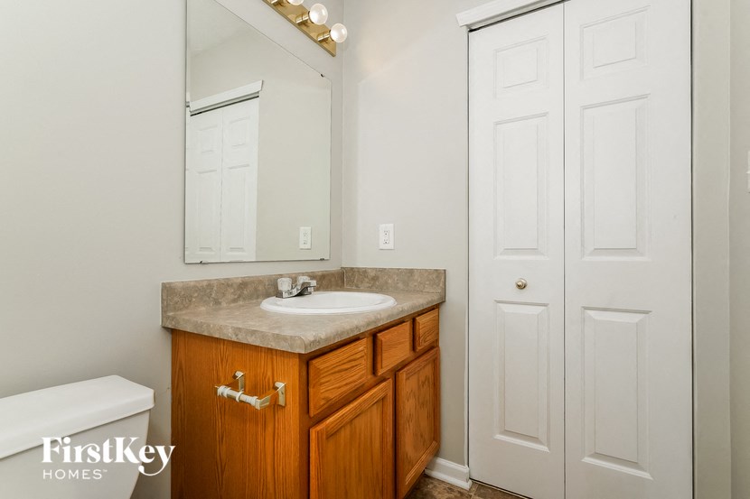 a bathroom with a sink and a mirror and a toilet