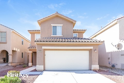 a beige house with a garage and a white door