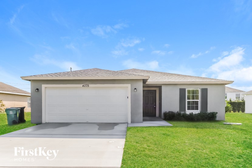 A house with a garage and a driveway is for sale.