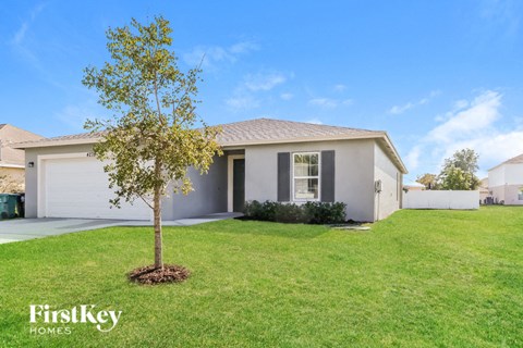 A house with a tree in front of it.