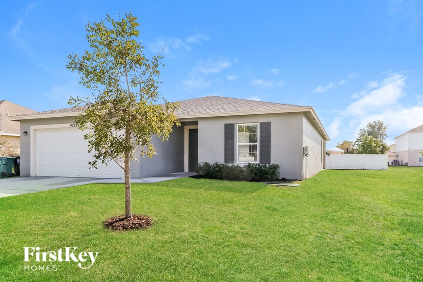 A house with a tree in front of it.