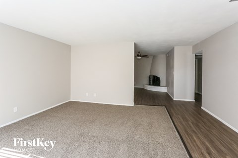 an empty living room with white walls and wood flooring