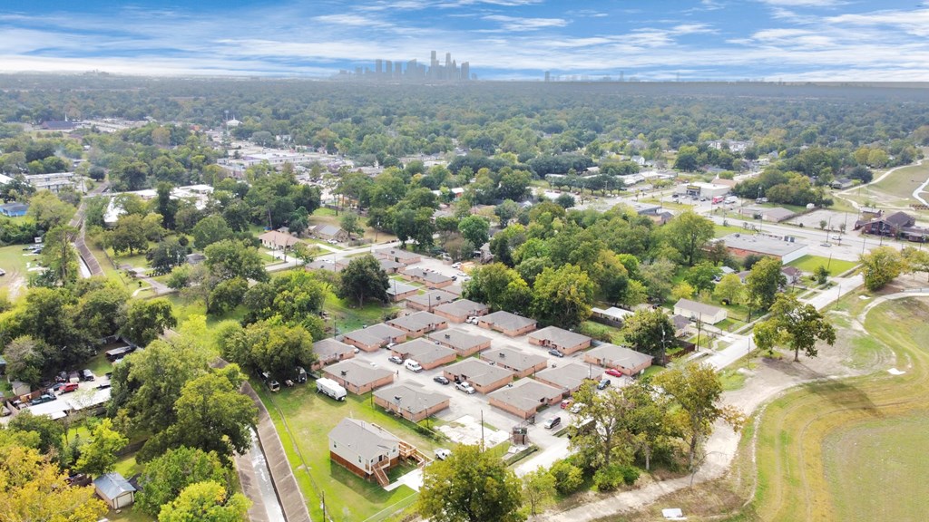 A bird's eye view of a residential area with houses and trees.