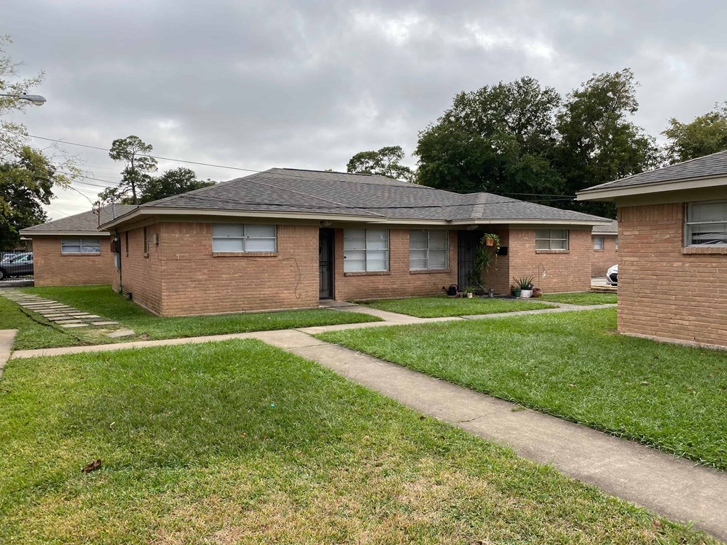 A house with a brown brick exterior and a grey roof.