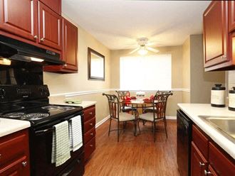 a kitchen and dining room with a table and chairs