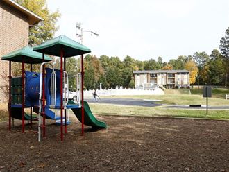 a playground at a park with a fountain