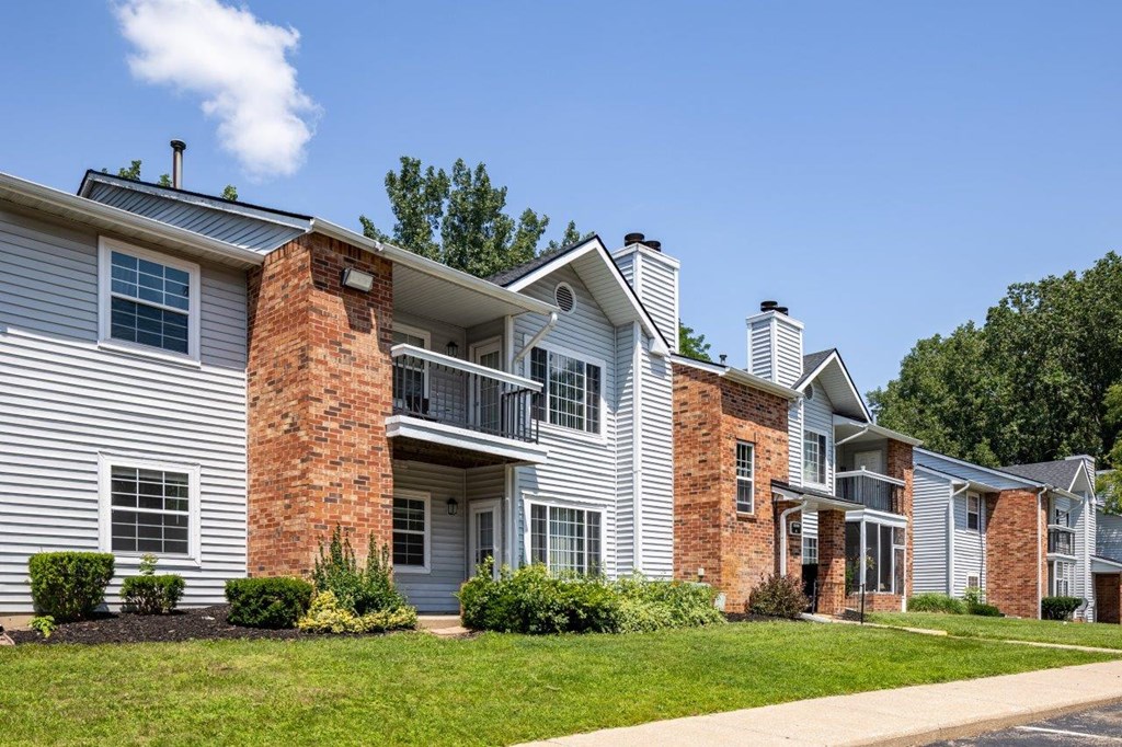 A row of houses with a clear blue sky above them.