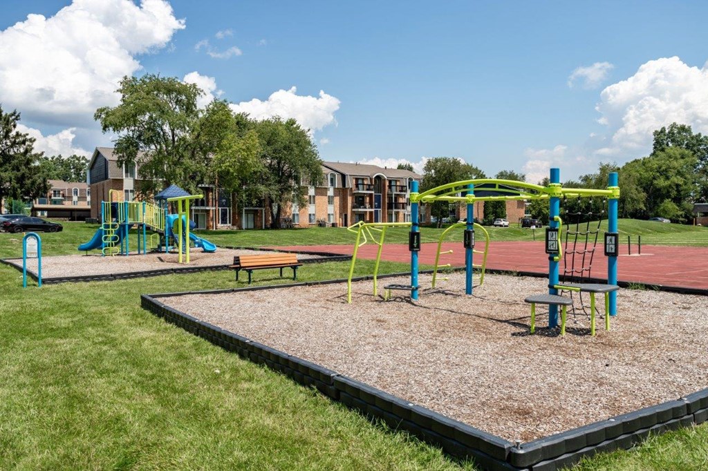 A playground with a swing set and a seesaw.