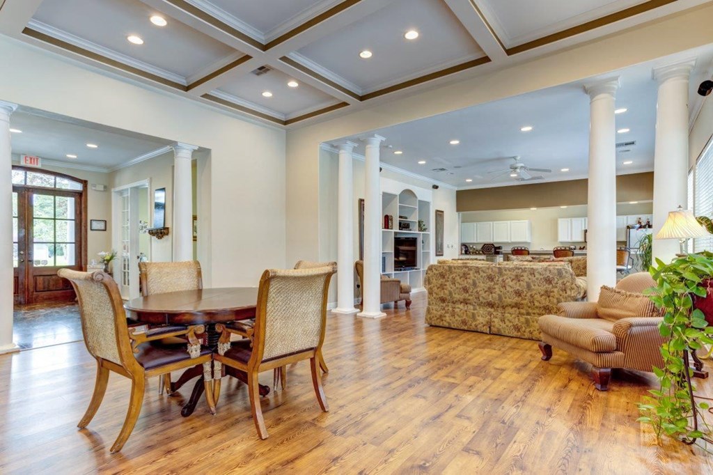 a dining room and living room with a couch and a table