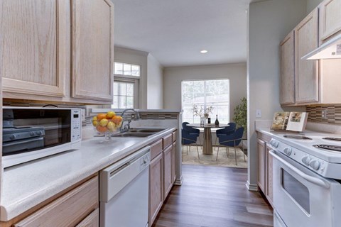 a kitchen with white appliances and wooden cabinets