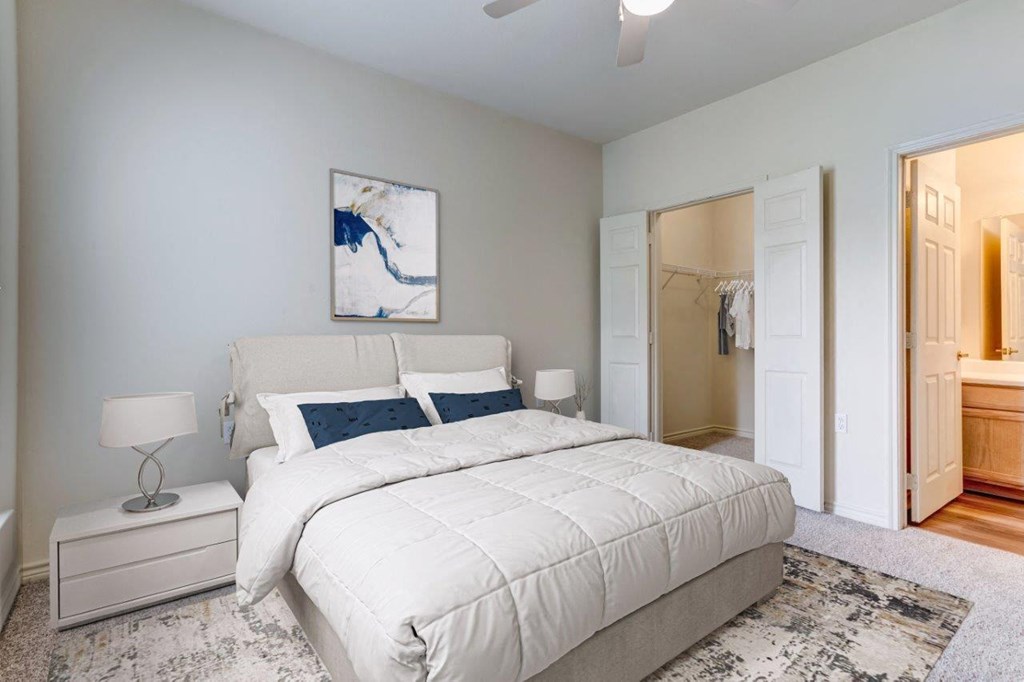 a bedroom with a white bed and a closet