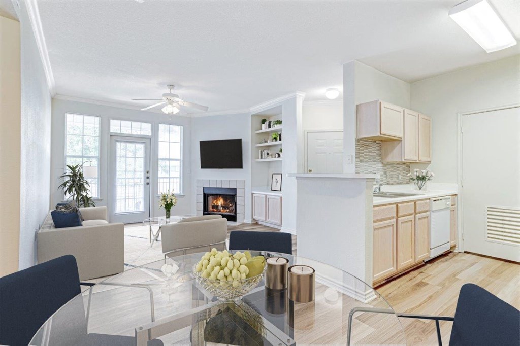 a living room with a glass table and a fireplace