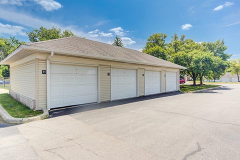 a white garage with white doors and a driveway
