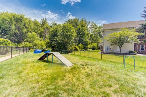 a backyard with a picnic table and a chain link fence