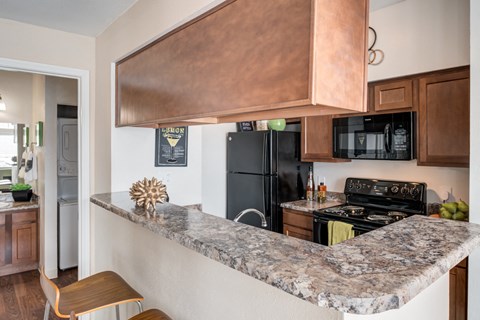 a kitchen with stainless steel appliances and a granite counter top