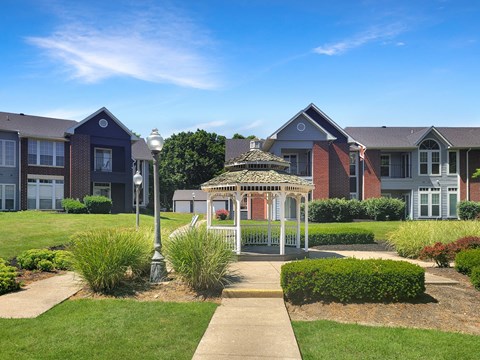 a gazebo in front of an apartment building