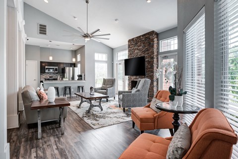 a living room with couches and chairs and a tv