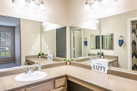 a bathroom with two sinks and a large mirror