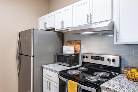 a kitchen with stainless steel appliances and white cabinets